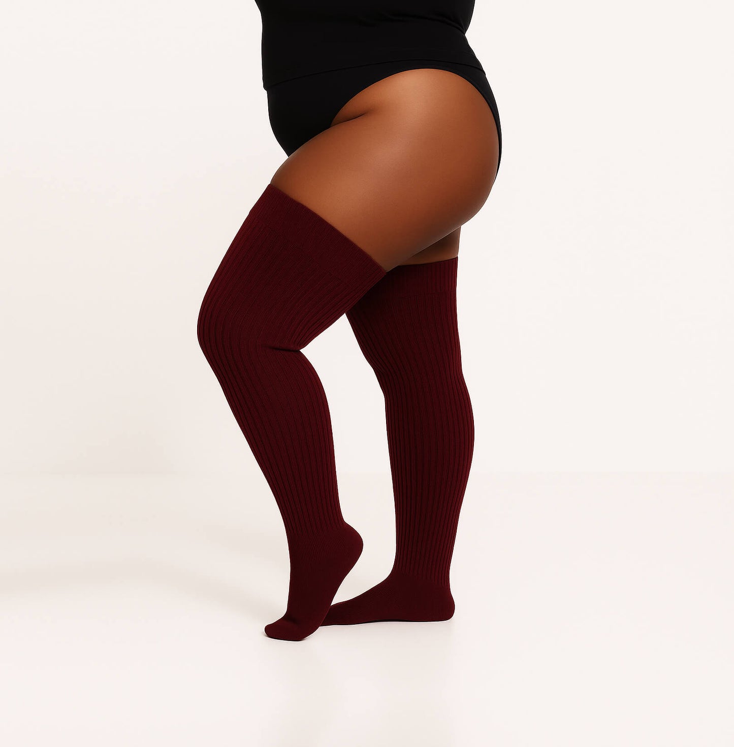 Plus size thigh high socks in a captivating maroon color, providing a fashionable and inclusive choice for all body types.