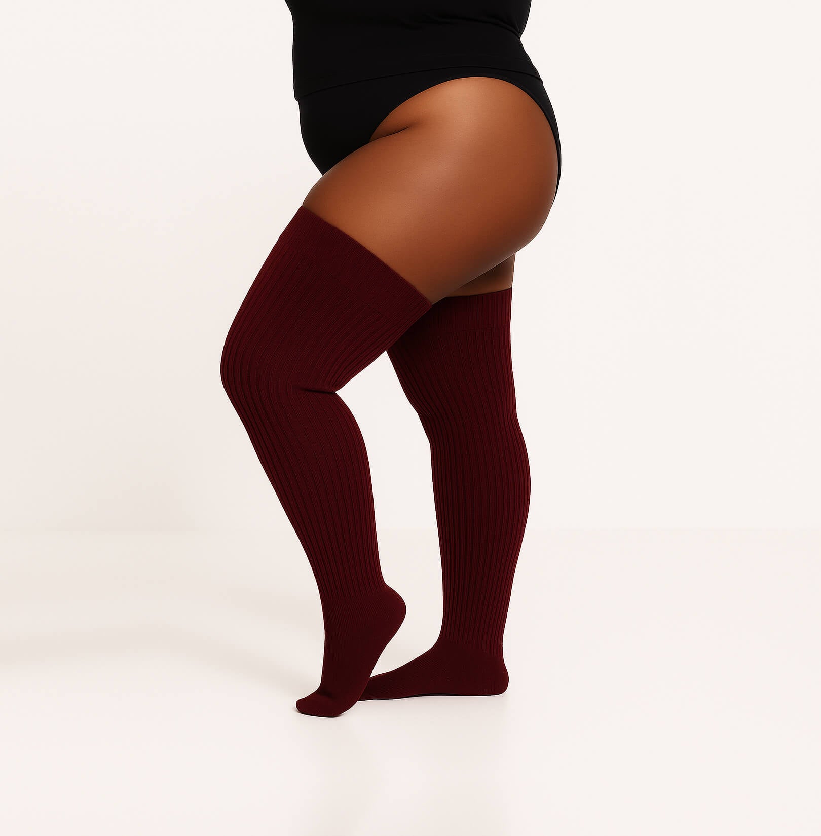 Plus size thigh high socks in a captivating maroon color, providing a fashionable and inclusive choice for all body types.