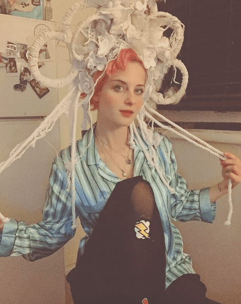 showcasing trendy sequined pop art tights, combining artistry and fashion for a striking ensemble.