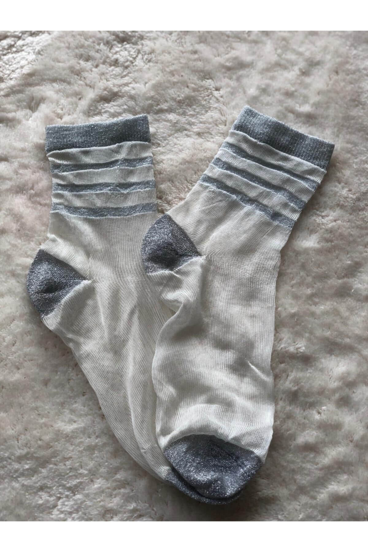 highlighting women's socks adorned with chic stripes and intricate lace, offering a trendy and eye-catching accessory.