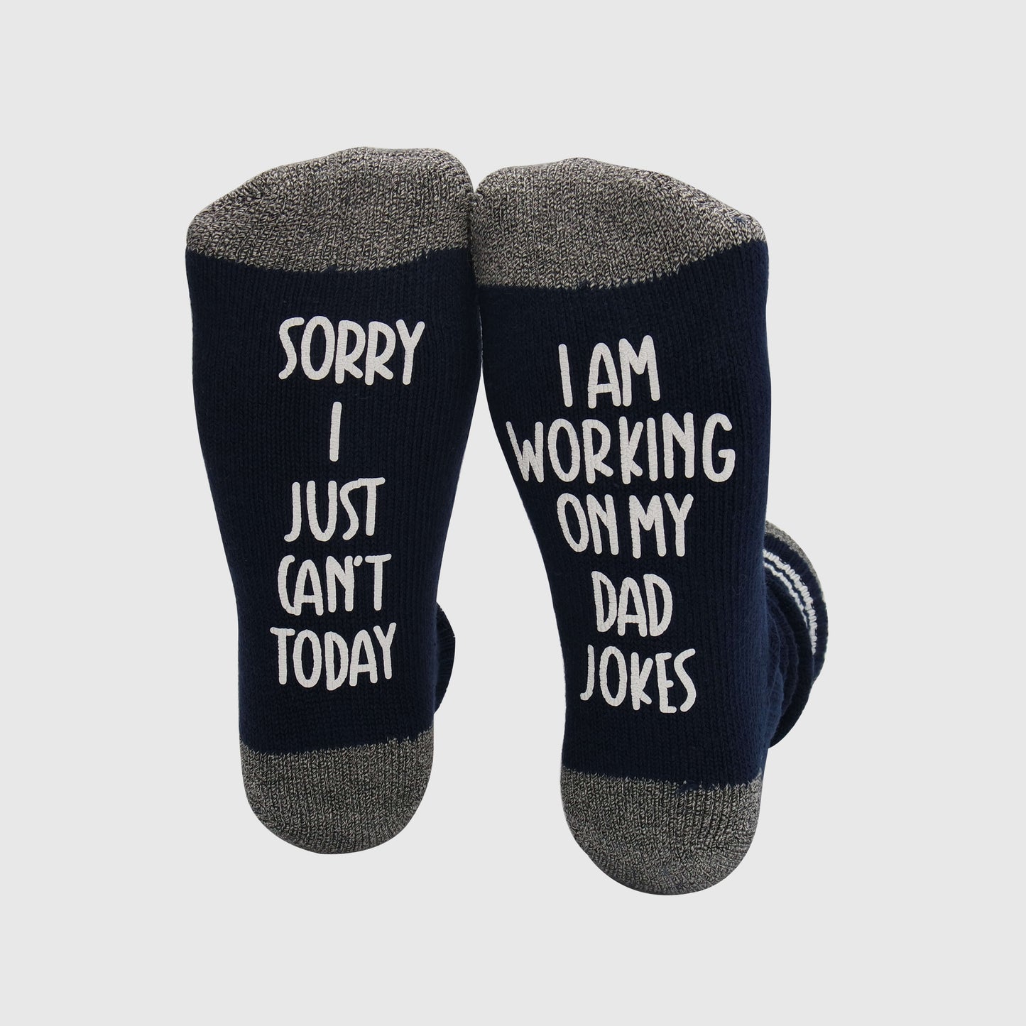 socks with a fun message, suggesting the wearer's engagement in crafting and practicing dad jokes with the phrase 'Sorry I just can't today, I am working on my dad jokes.'