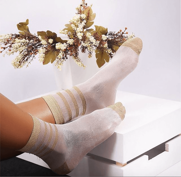 featuring fashionable women's socks with striped patterns and delicate lace embellishments, perfect for adding flair to any ensemble.