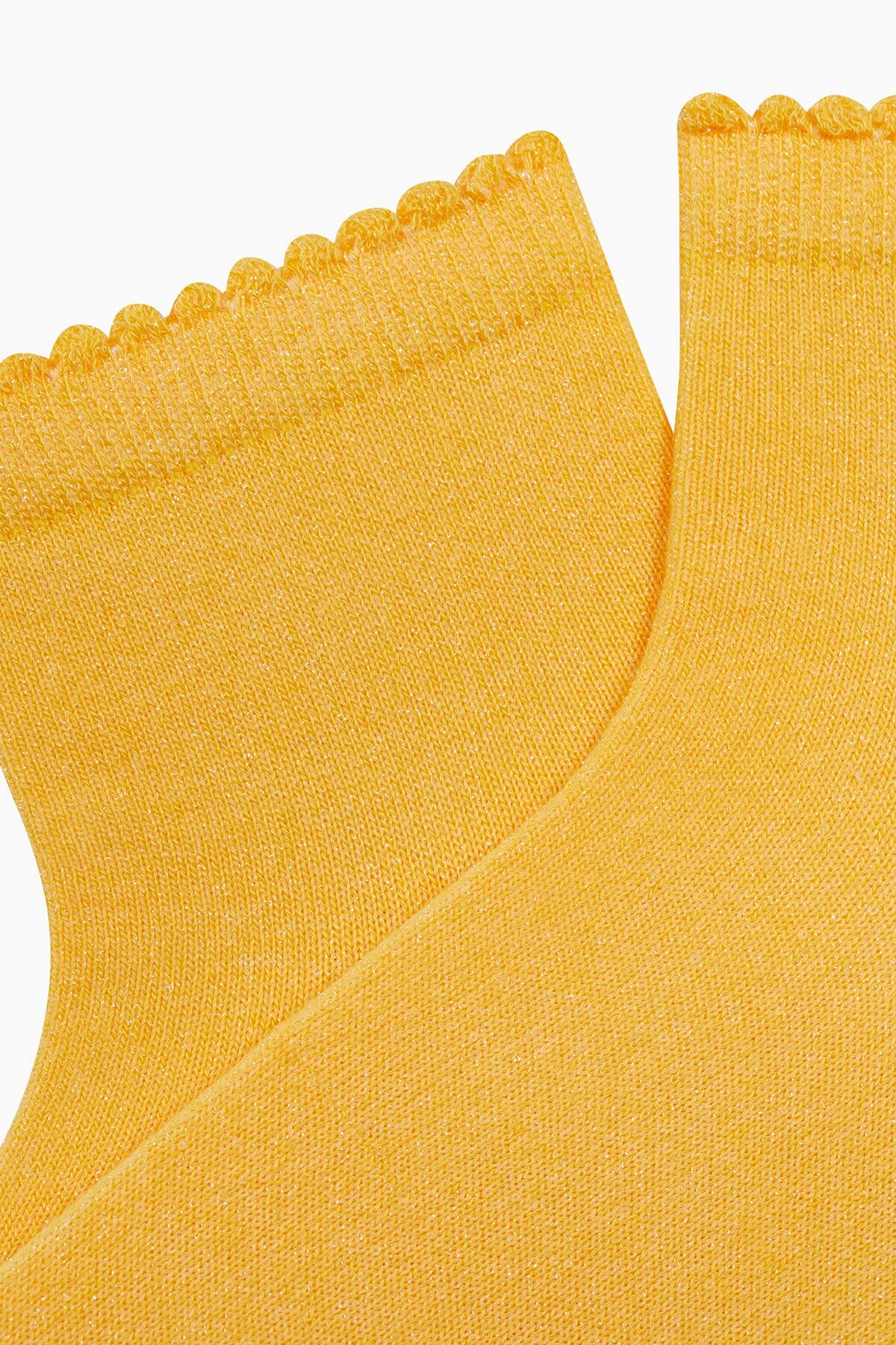 yellow glitter socks, adding a sparkling and vibrant touch to any outfit.
