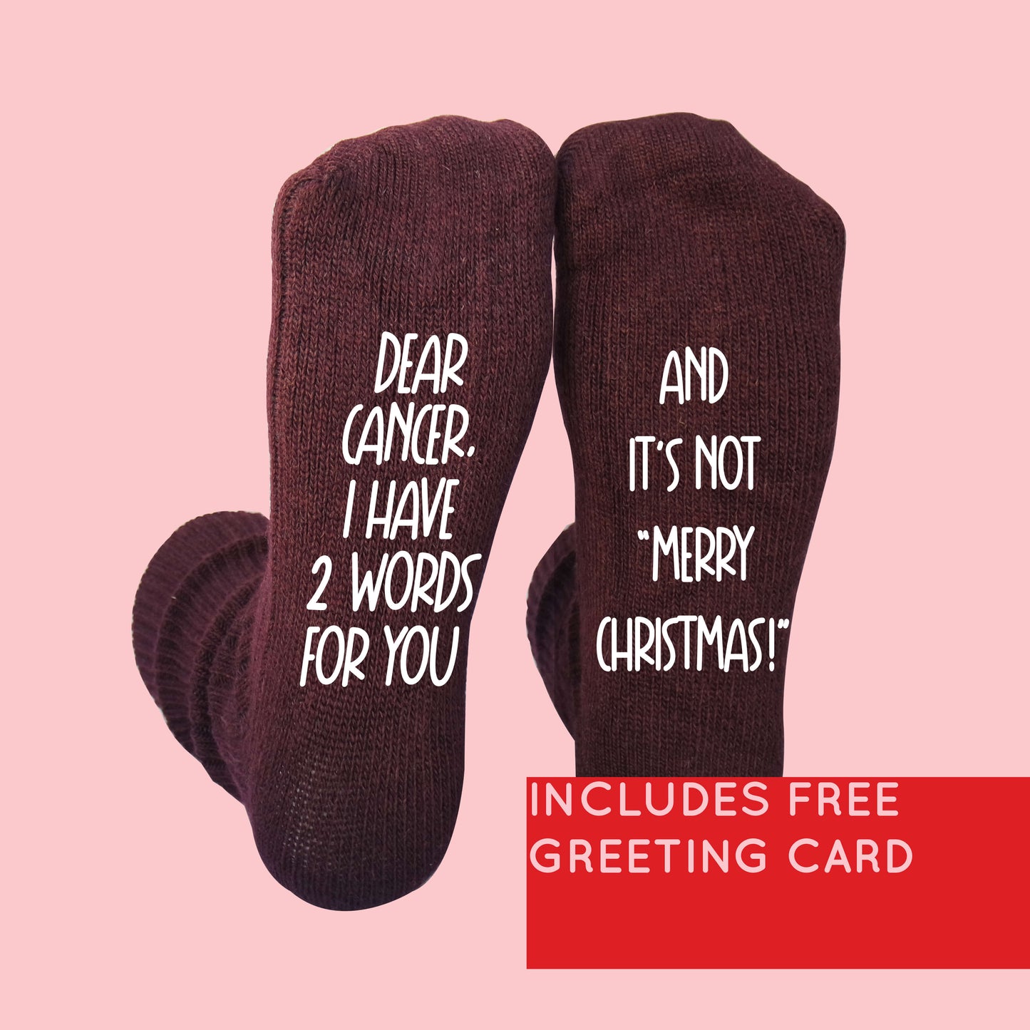 Maroon socks with a bold message printed in white text. The left sock reads: 'Dear cancer. I have 2 words for you,' and the right sock continues: 'And it’s not “Merry Christmas!”' A red banner in the bottom right corner states, 'Includes free greeting card.' Perfect gift for cancer survivors or supporters with a strong message.