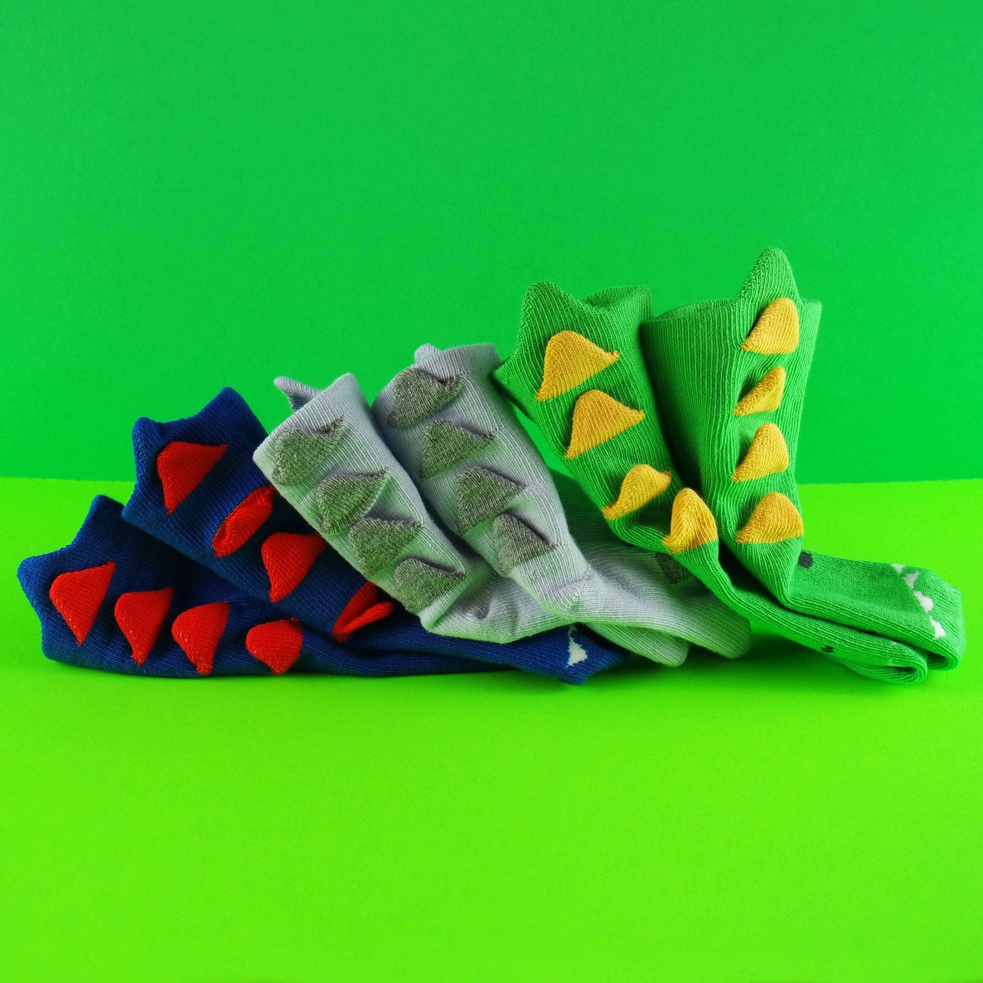 Colorful 3D navy blue dinosaur baby socks designed with a whimsical dinosaur pattern.