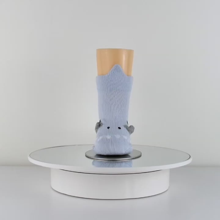 playful 3D baby dinosaur socks in a video, showcasing its adorable movements and features