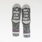 socks with a humorous statement about pregnancy, expressing the physical and emotional journey of growing a baby.