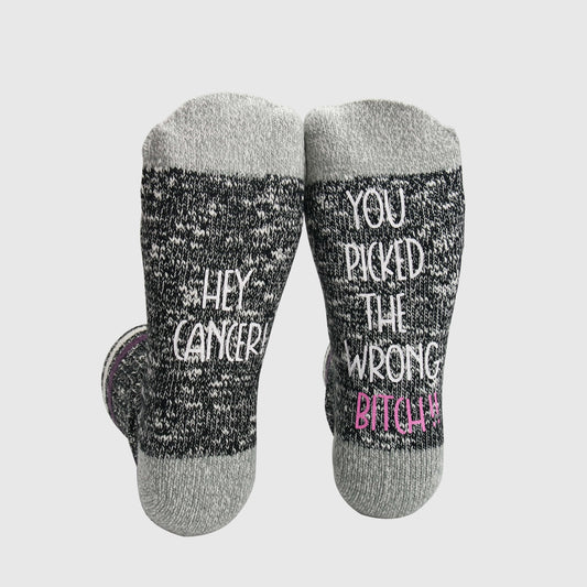 socks with the empowering phrase &#39;Hey Cancer, You Picked the Wrong Bitch,&#39; symbolizing strength and resilience in the face of cancer.