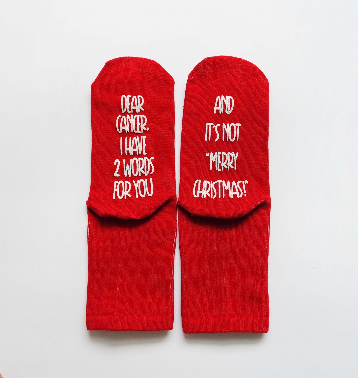 Red Christmas Socks with a resolute message for women, challenging cancer and embodying unwavering determination.