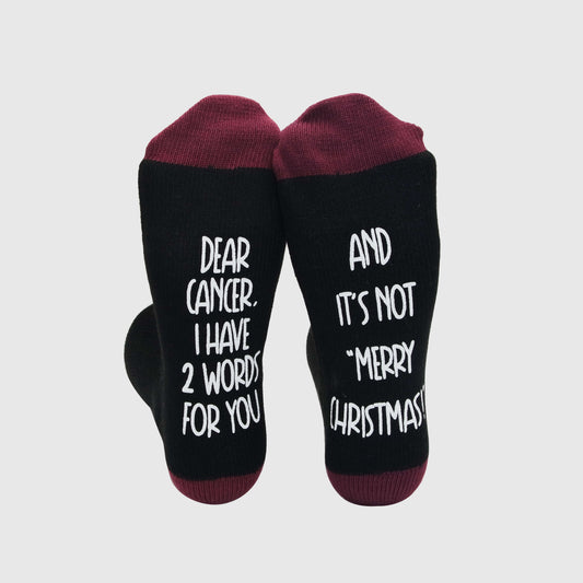 Socks for men with a bold message directed at cancer, reflecting a fighting spirit.