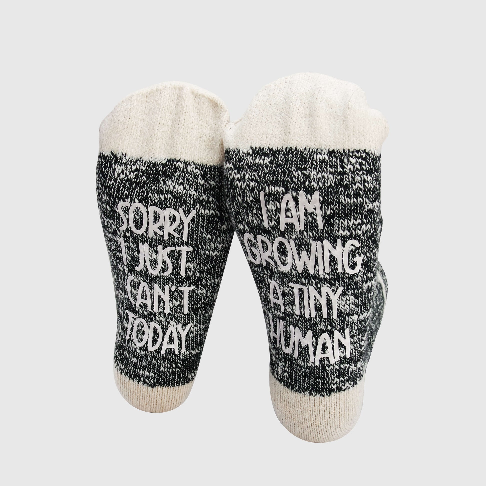 Socks with a lighthearted message for expectant mothers, reflecting the realities of pregnancy with the phrase 'Sorry I just can't today, I am growing a tiny human