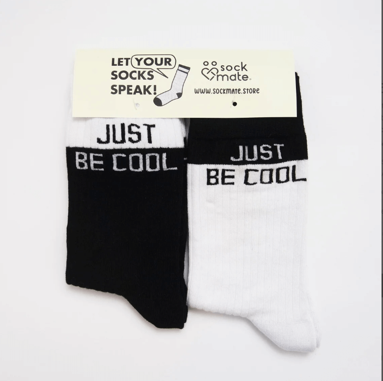 couple's socks with the phrase 'Just Be Cool,' conveying a lighthearted and fun message."