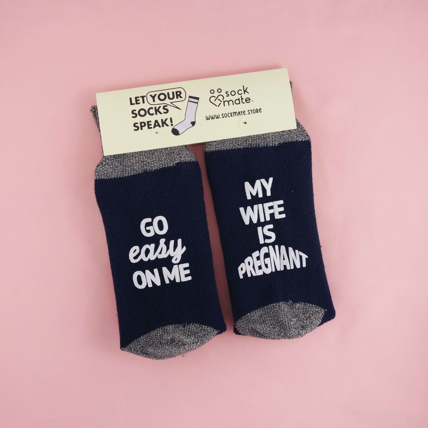 Socks featuring a playful and supportive pregnancy message, encouraging empathy and kindness for expectant fathers with the phrases 'GO EASY ON ME' and 'MY WIFE IS PREGNANT.