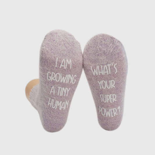  featuring socks with a humorous statement about pregnancy, expressing the physical and emotional journey of growing a baby.