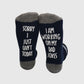  socks with a fun message, suggesting the wearer's engagement in crafting and practicing dad jokes with the phrase 'Sorry I just can't today, I am working on my dad jokes.'