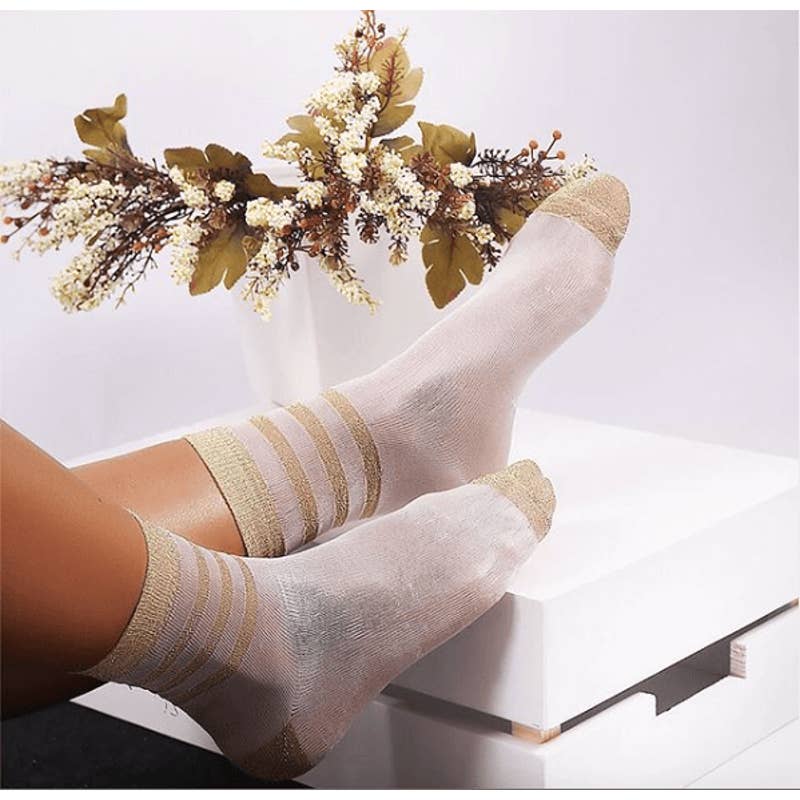 Showcasing women's sheer socks with elegant black stripes, adding a touch of allure and sophistication to the ensemble.
