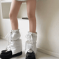 Cozy quilted leg warmer boot sleeves in gray, adjustable with laces, layered over running shoes for a puffy look.