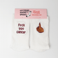 A pair of white embroidered socks from Sockmate, shown with pink branded packaging labeled “Let Your Socks Speak!” and “www.sockmate.store.” One sock reads “fuck you cancer” in red embroidery, and the other shows a hand with red nail polish giving the middle finger. Supportive and empowering gift socks for cancer fighters and survivors.
