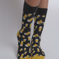 Add a touch of quirkiness to your wardrobe with these patterned socks. The design includes bananas, hotdogs, beer mugs, cheese, hot sauce, and avocados – a conversation starter for sure!"