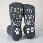 Gray socks with text and paw prints on a light background
