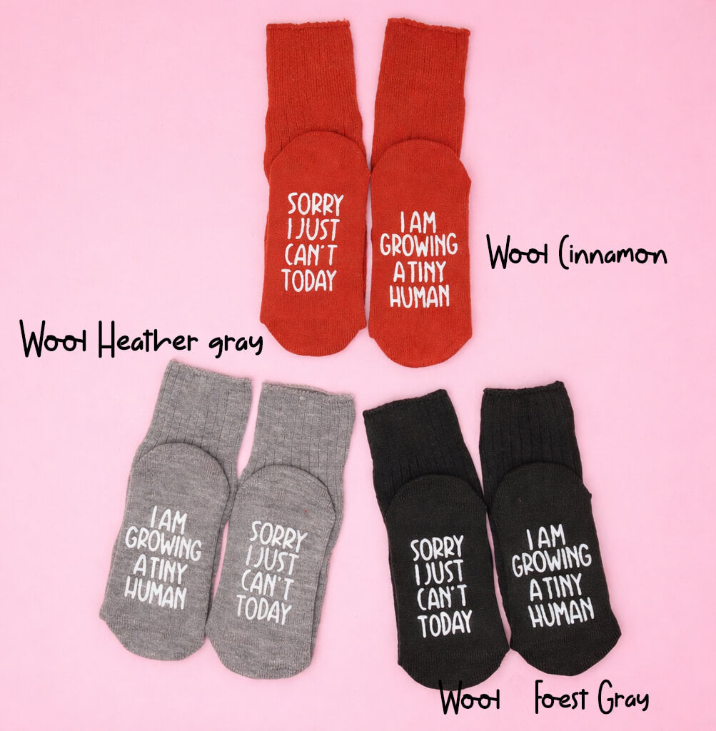 3 pairs of socks in different colors with humorous text on a pink background.