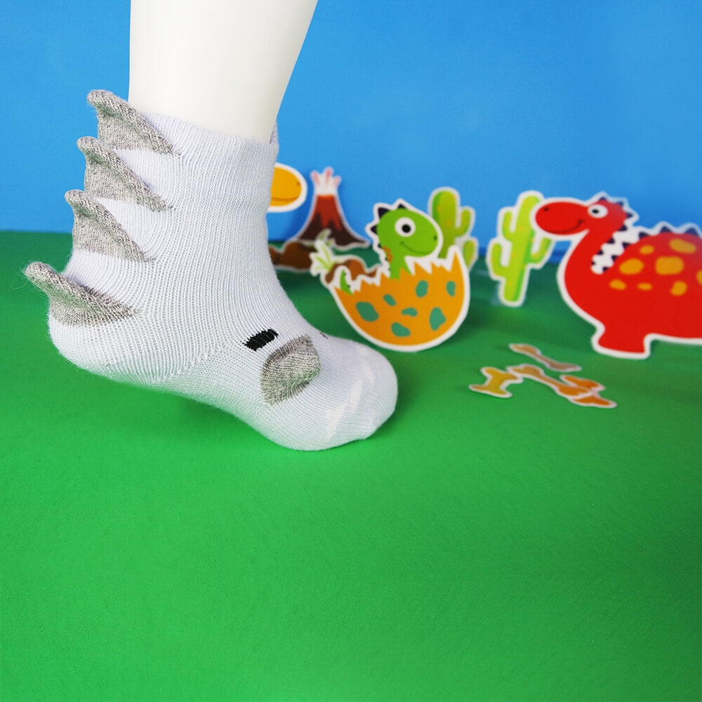 Captivating 3D blue gray dinosaur baby socks, showcasing a playful dinosaur illustration.
