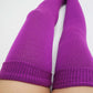 a woman wears purple color plus size thigh high make her cozy in bed
