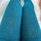 showcasing thigh high socks in a lovely teal hue, a chic and trendy addition to any plus size wardrobe.
