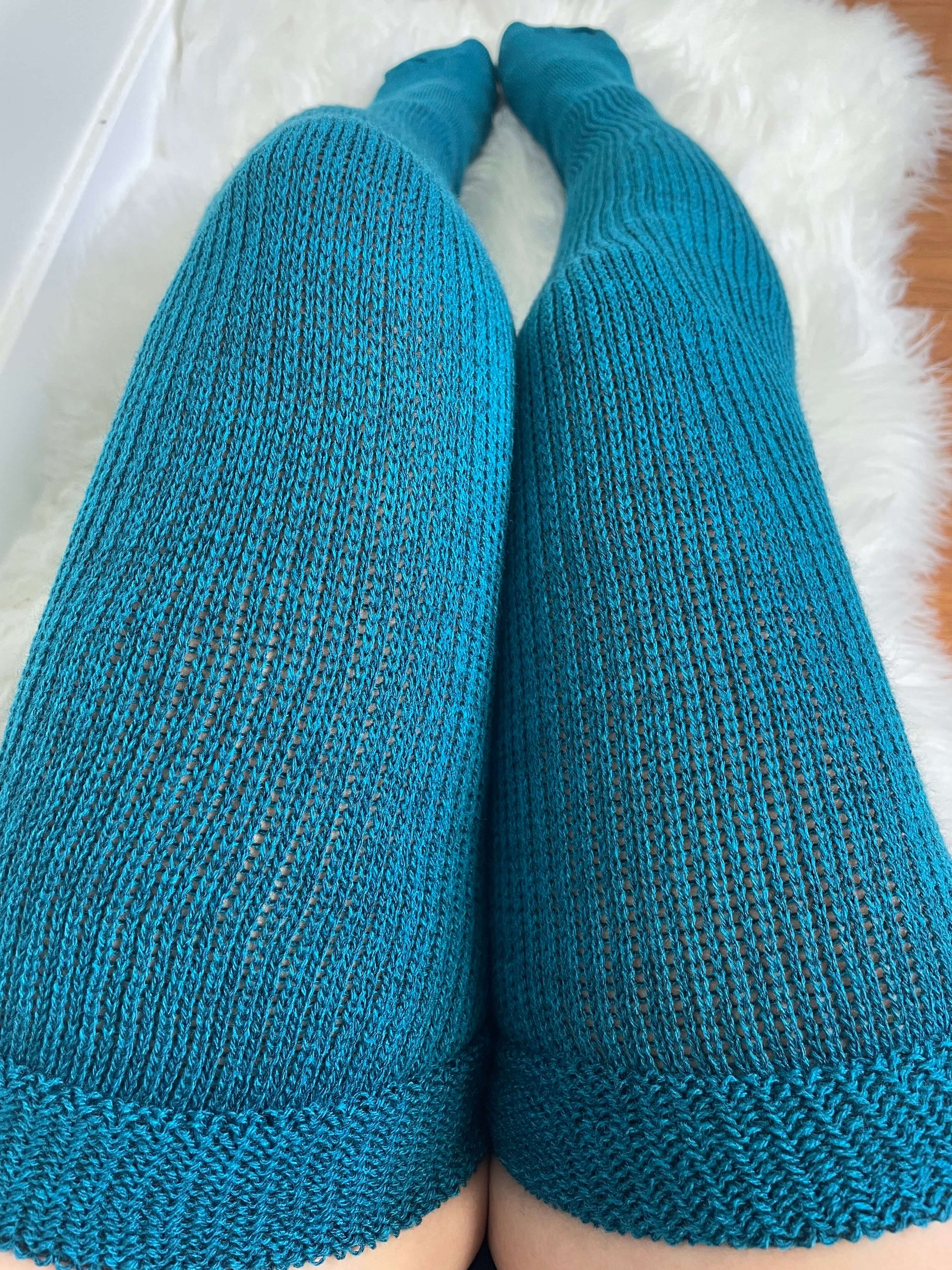 showcasing thigh high socks in a lovely teal hue, a chic and trendy addition to any plus size wardrobe.