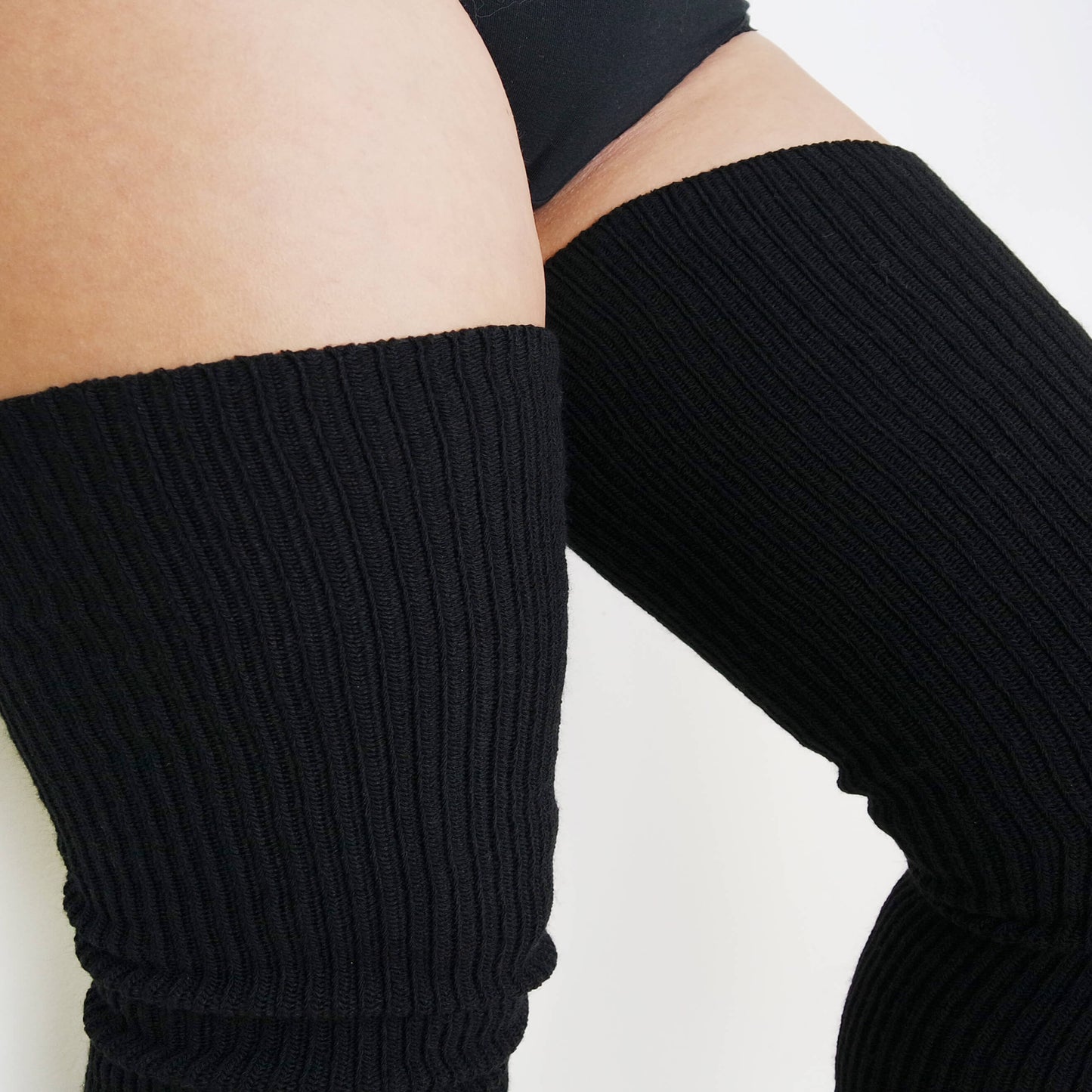 plus size woman wears ribbed style thigh high socks